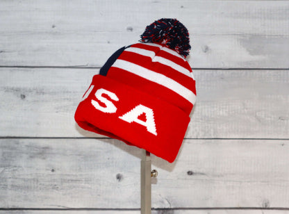 Child Specialty Hat (Ages 3–5) – Playful Warmth with Purpose in red and white with a pom-pom on top.