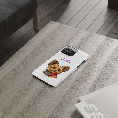 Custom dog cartoon phone case with a Yorkie design and name Stella, placed on a wooden table.