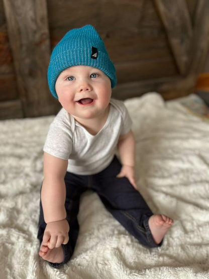 Infant Acrylic Cuff Hat – Soft Knit Beanie for Ages 3–12M worn by a smiling baby on a blanket.