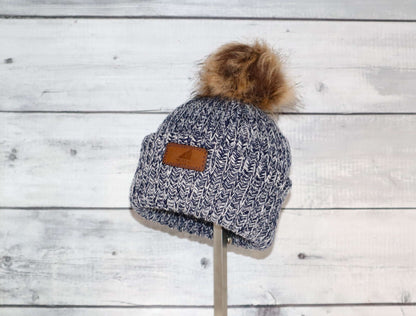 Toddler Acrylic Ribbed Cuff with Pom Hat – Cozy & Purposeful displayed on a wooden background.