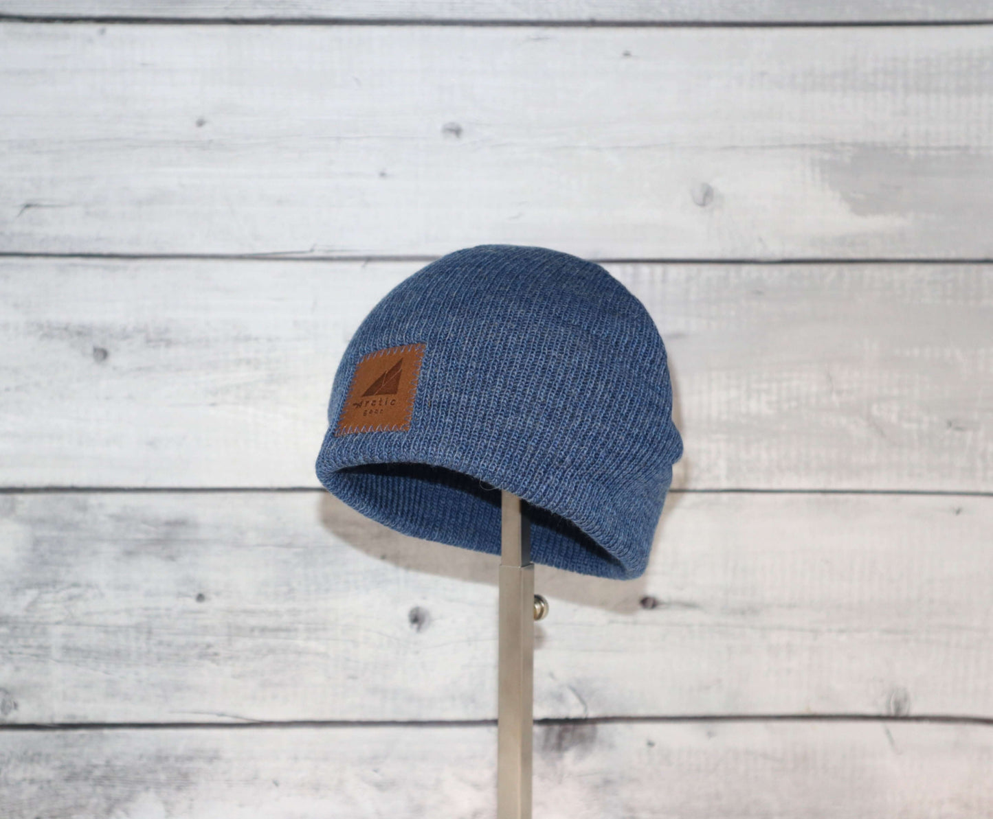 Toddler Acrylic Wool Beanie – Soft, Stretchy & Winter-Ready in blue color on display against a wooden background.