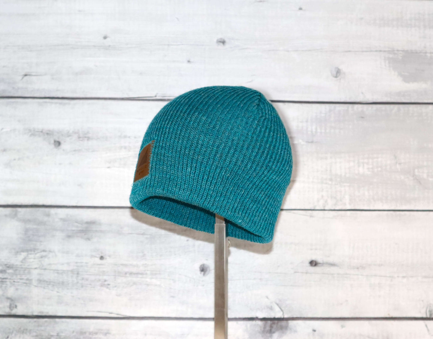 Toddler Acrylic Wool Beanie – Soft, Stretchy & Winter-Ready displayed on a wooden background.