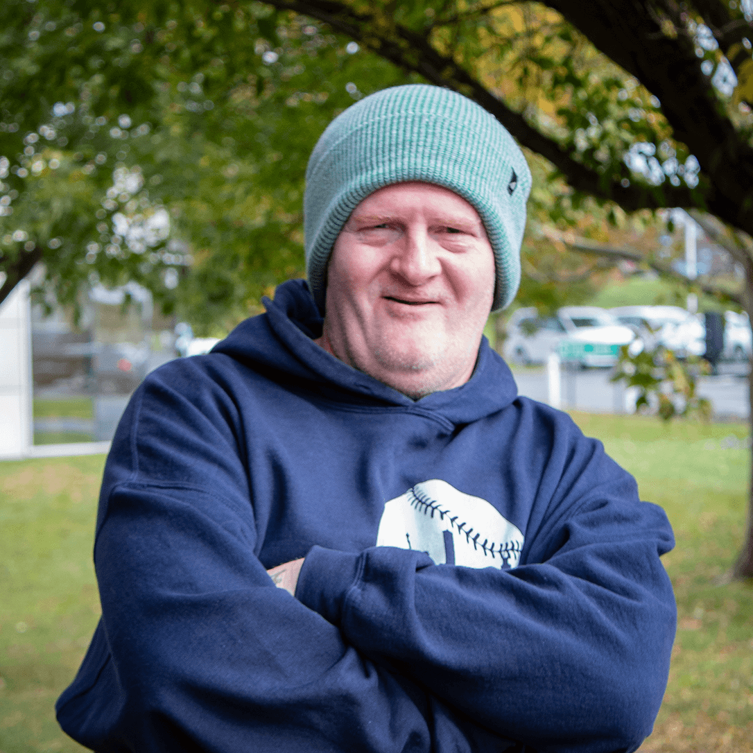 Adult Acrylic Cuff Hat – Soft Knit Beanie worn by a man outdoors, showcasing comfort and style in a casual setting.