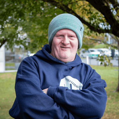 Adult Acrylic Cuff Hat – Soft Knit Beanie worn by a man outdoors, showcasing comfort and style in a casual setting.