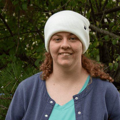 Adult Acrylic Cuff Hat – Soft Knit Beanie worn by a woman in a natural outdoor setting.