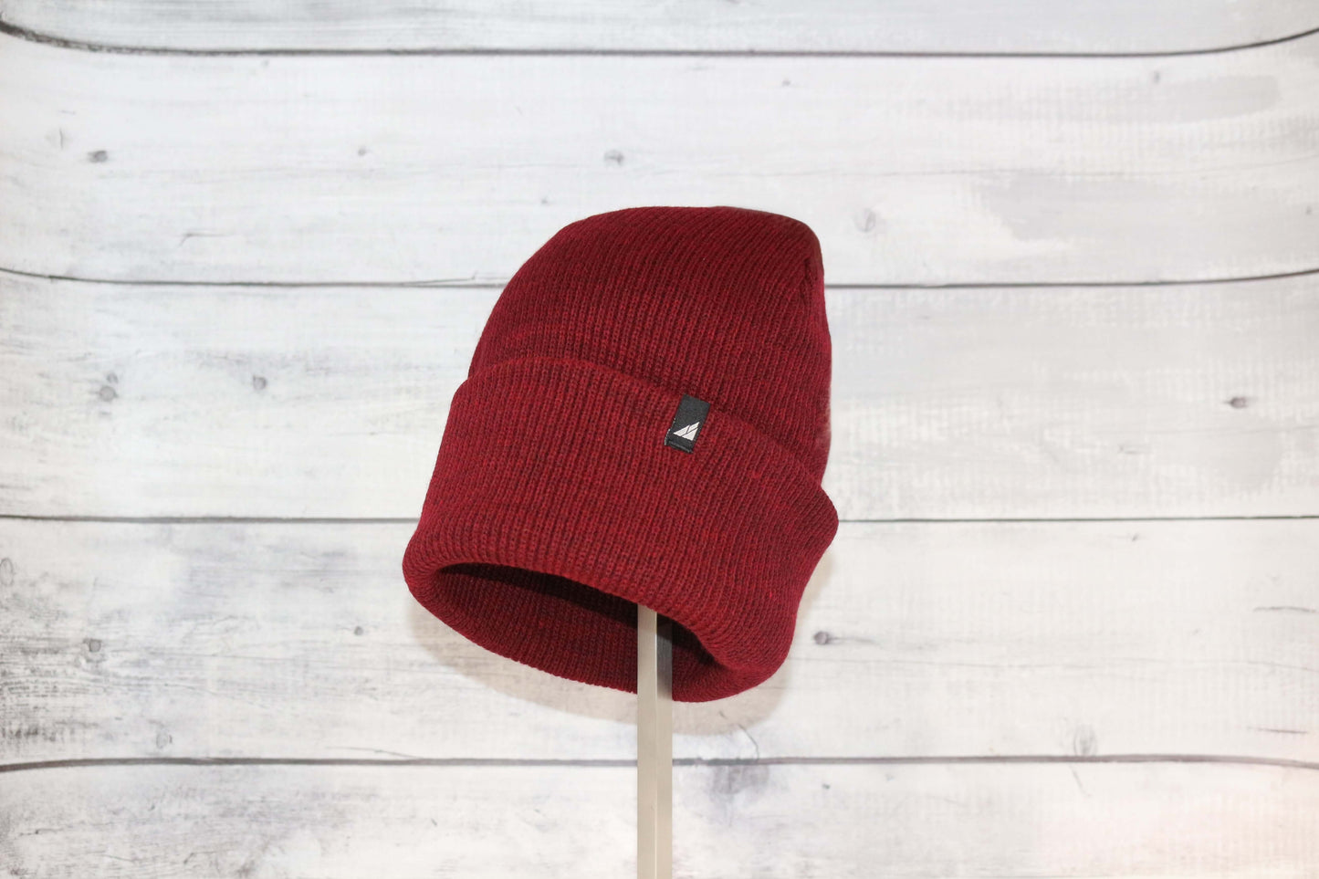 Adult Acrylic Cuff Hat – Soft Knit Beanie in red on display, showcasing its cozy design and snug fit.