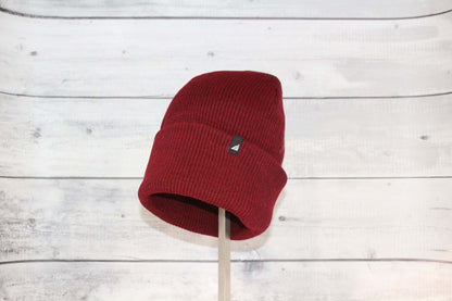 Adult Acrylic Cuff Hat – Soft Knit Beanie in red on display, showcasing its cozy design and snug fit.