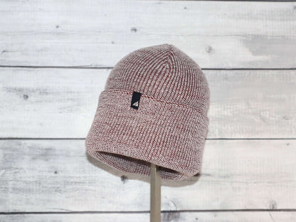 Adult Acrylic Cuff Hat – Soft Knit Beanie displayed on a stand against a rustic wooden background.