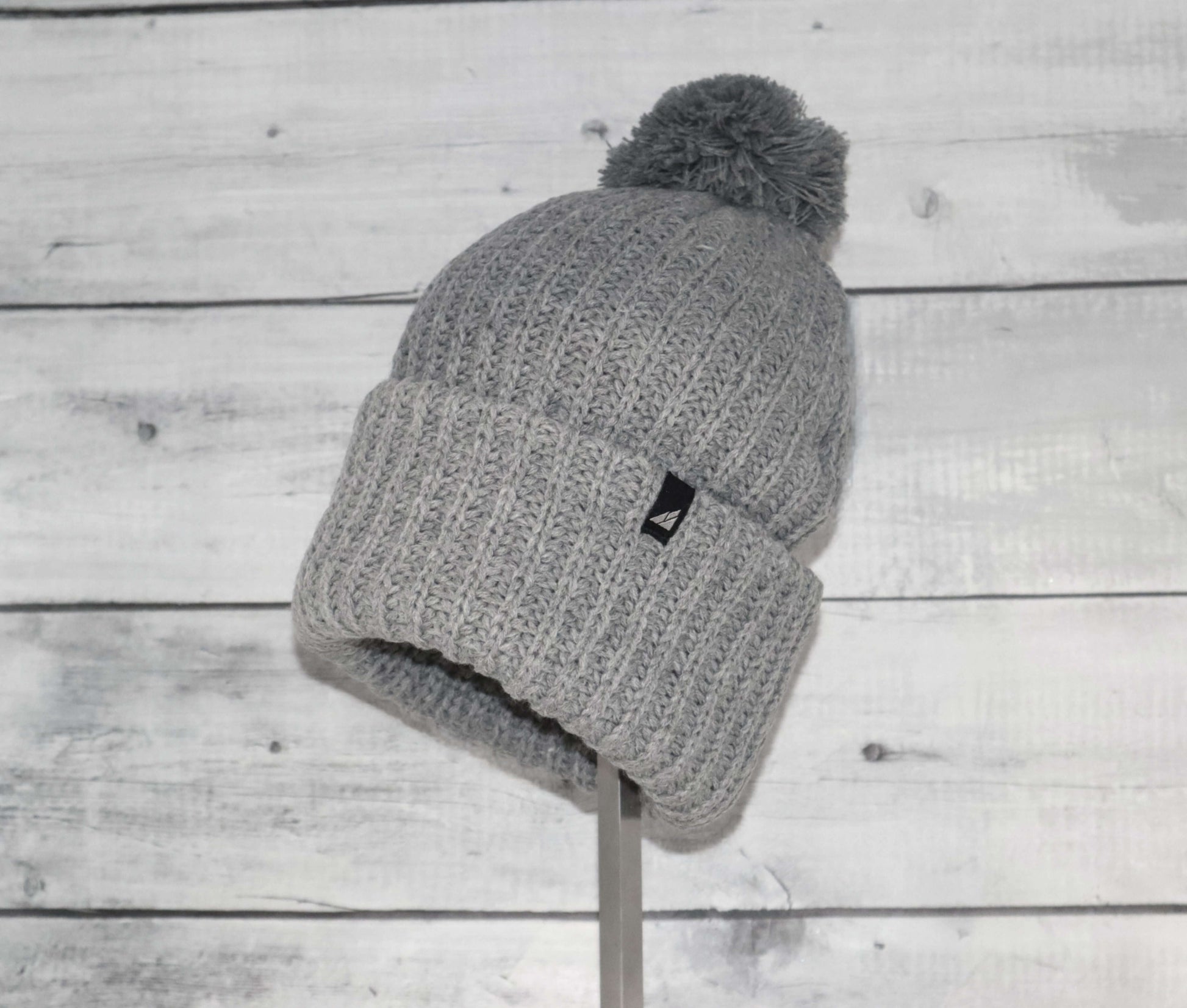 Adult Acrylic Ribbed Cuff Hat with Matching Pom – Cozy & Classic in gray color on display.
