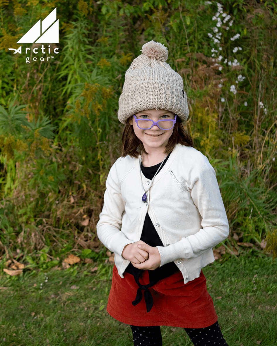 Adult Acrylic Ribbed Cuff Hat with Matching Pom – Cozy & Classic worn by a smiling girl outdoors.