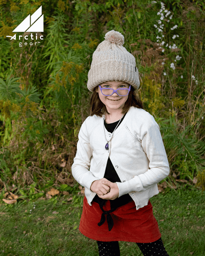Adult Acrylic Ribbed Cuff Hat with Matching Pom – Cozy & Classic worn by a smiling girl outdoors.