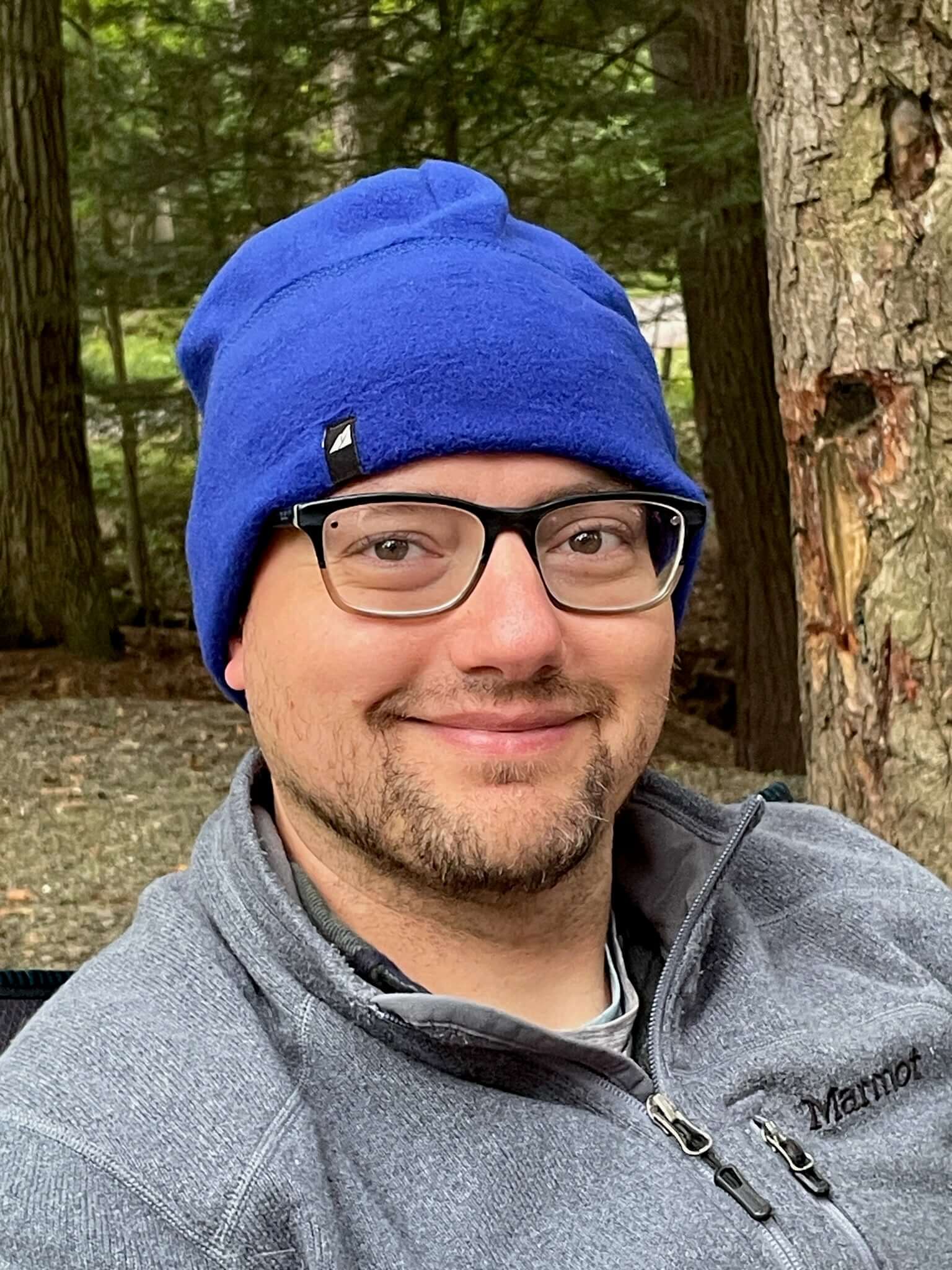 Adult Fleece Cap – Warm Stretch Beanie worn by a man in a casual outdoor setting, designed for warmth and comfort.