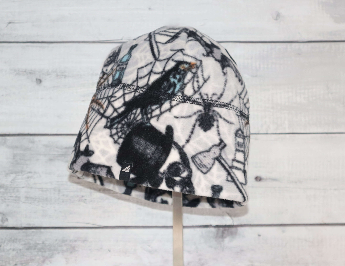 Adult Fleece Cap – Warm Stretch Beanie with spider and web design, perfect for cold weather wear.