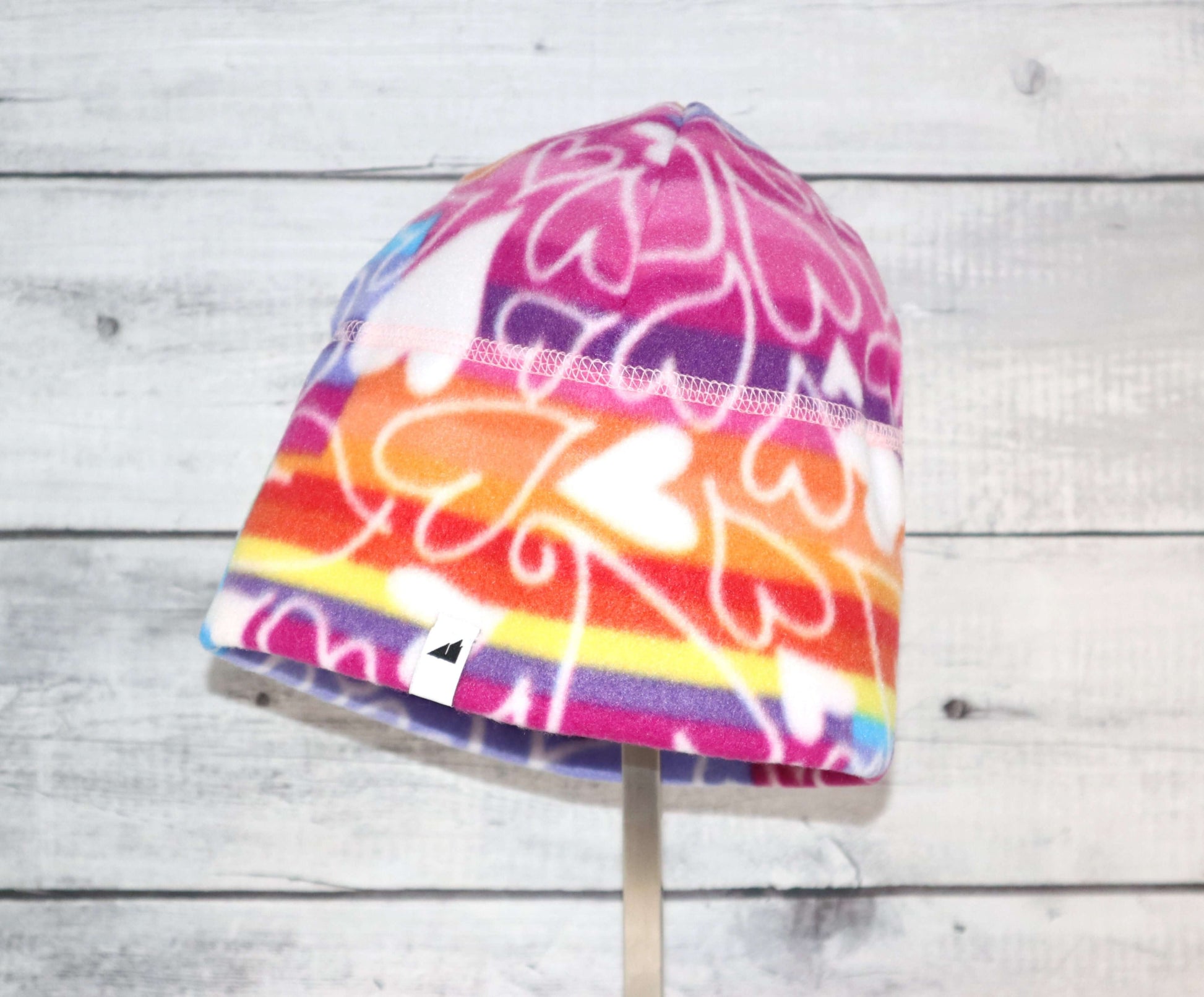 Adult Fleece Cap – Warm Stretch Beanie featuring colorful heart patterns for warmth and comfort in cold weather.