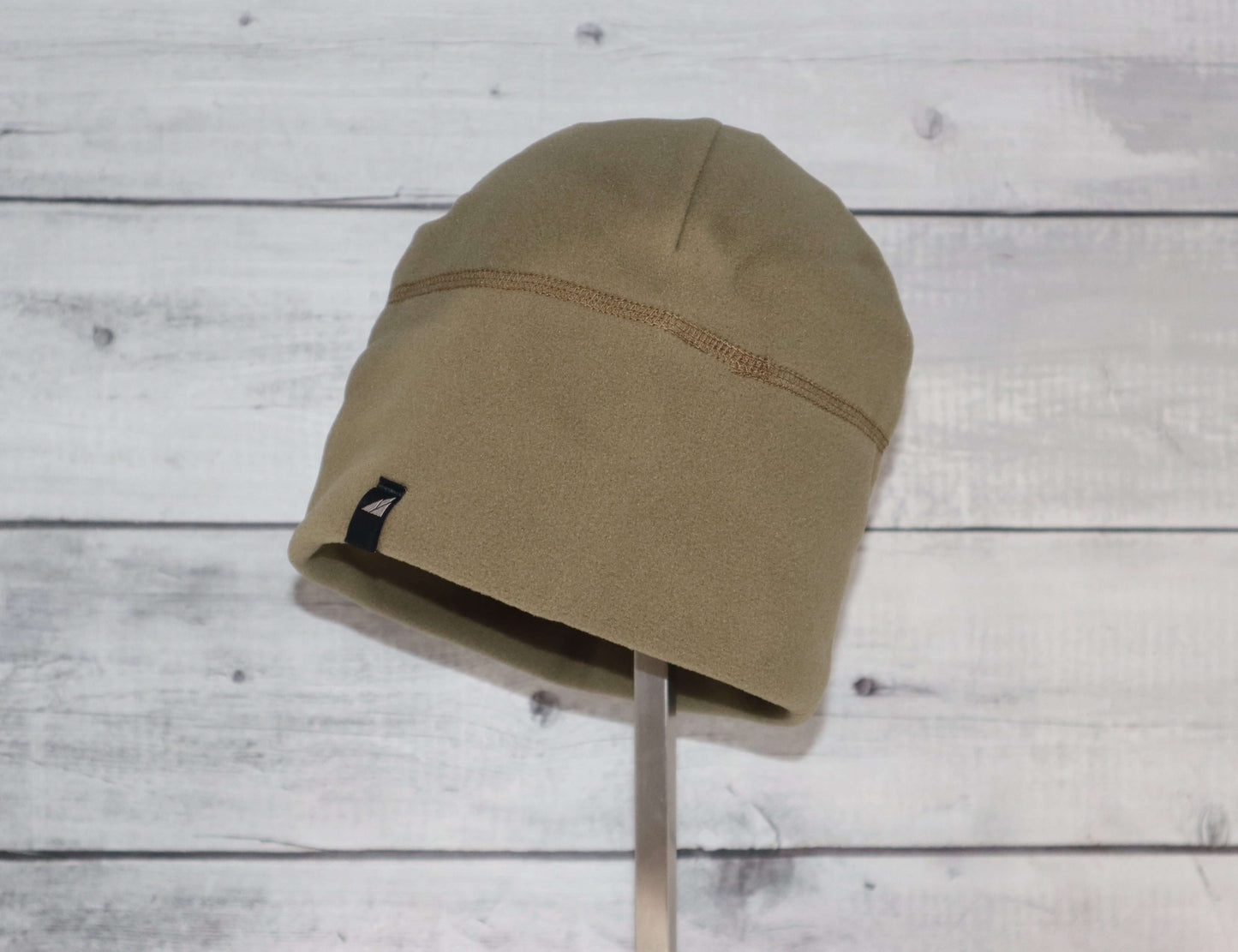 Adult Fleece Cap – Warm Stretch Beanie displayed on a stand, showcasing its soft fleece design.