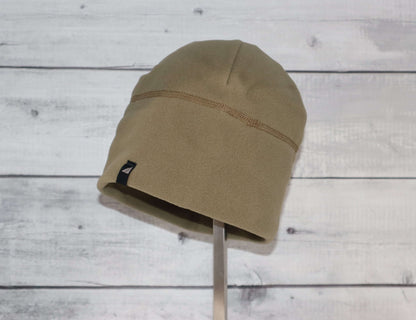 Adult Fleece Cap – Warm Stretch Beanie displayed on a stand, showcasing its soft fleece design.