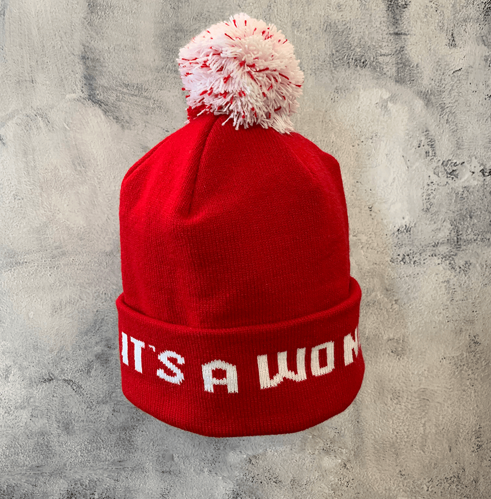 Adult Limited Edition Hat – Bedford Falls Beanie in red with pom-pom and woven letters saying IT'S A WONDERFUL LIFE.