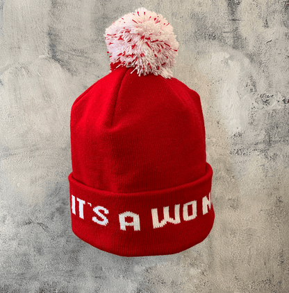 Adult Limited Edition Hat – Bedford Falls Beanie in red with pom-pom and woven letters saying IT'S A WONDERFUL LIFE.