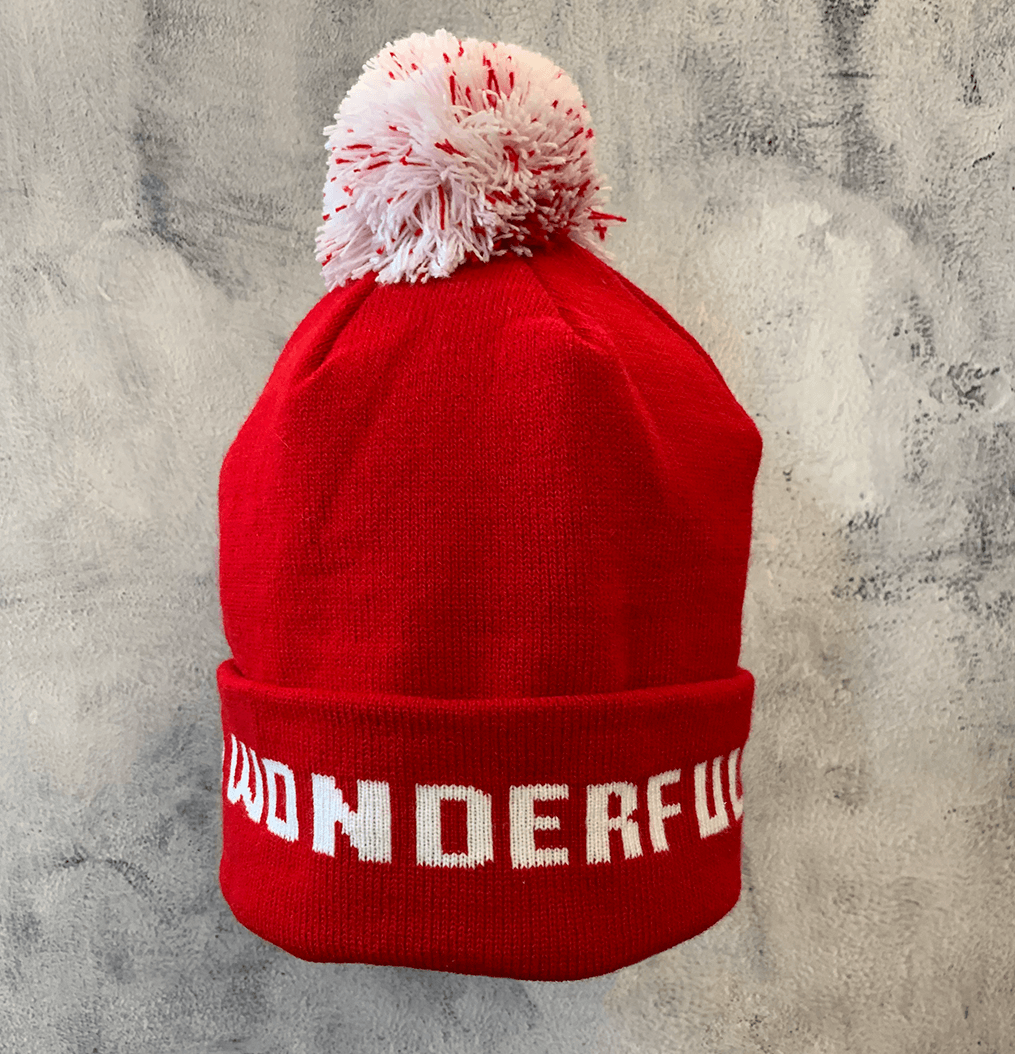 Adult Limited Edition Hat – Bedford Falls Beanie in red with white pom-pom and 'WONDERFUL' text design.