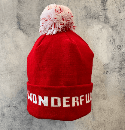 Adult Limited Edition Hat – Bedford Falls Beanie in red with white pom-pom and 'WONDERFUL' text design.