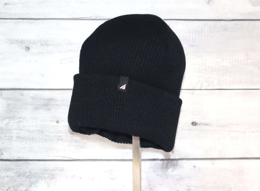 Adult Versatile Wool Watch Cap – Flexible Fit Winter Beanie in black on a wooden background.