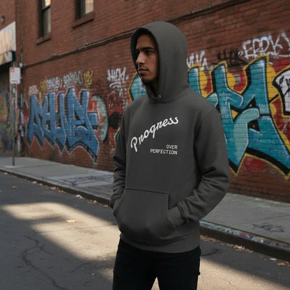 Affirmation Arc Hoodie – Custom Mantra & Value worn by a man in a street with graffiti background.