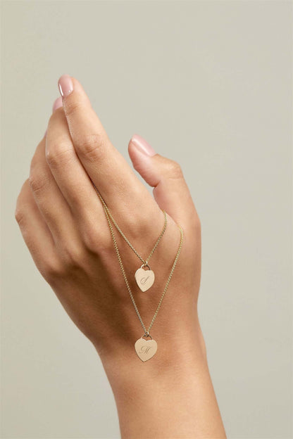 Alice Initial Necklace – Personalized 14k Gold-Filled Heart displayed elegantly on a hand with two heart charms.