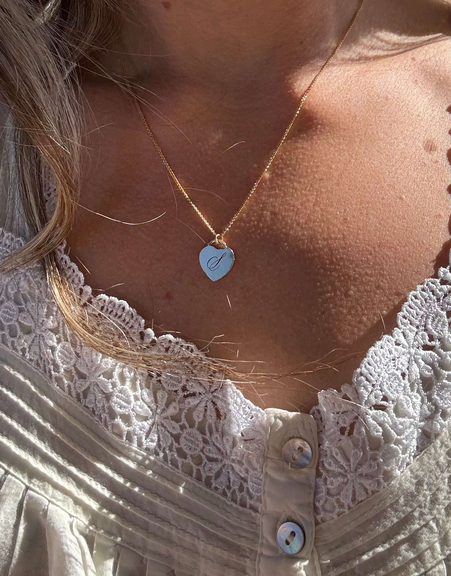 Alice Initial Necklace – Personalized 14k Gold-Filled Heart elegantly displayed on a model, featuring a heart charm.