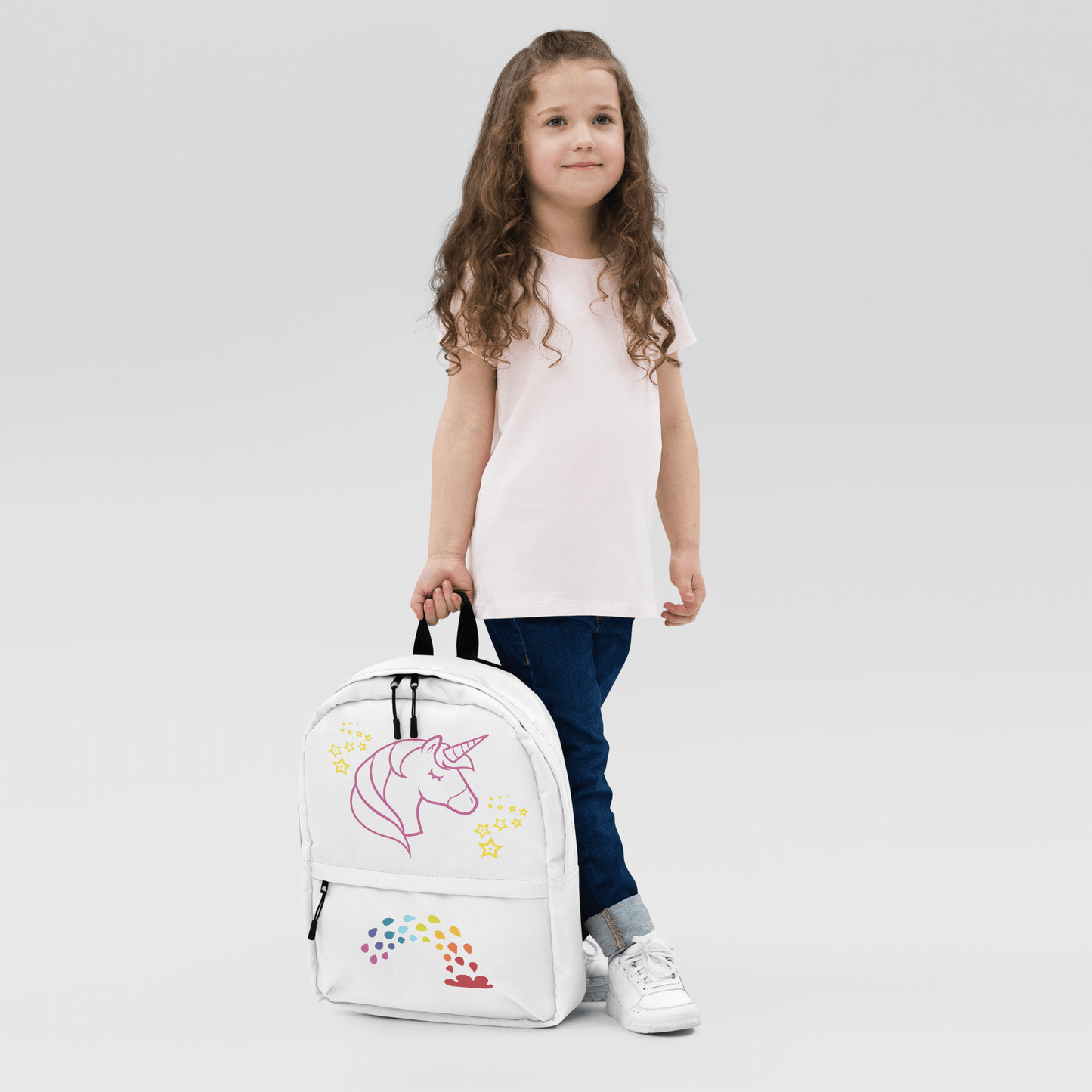 Child with Unicorn Dreams Backpack featuring whimsical unicorn and rainbow design, perfect for school or adventures.
