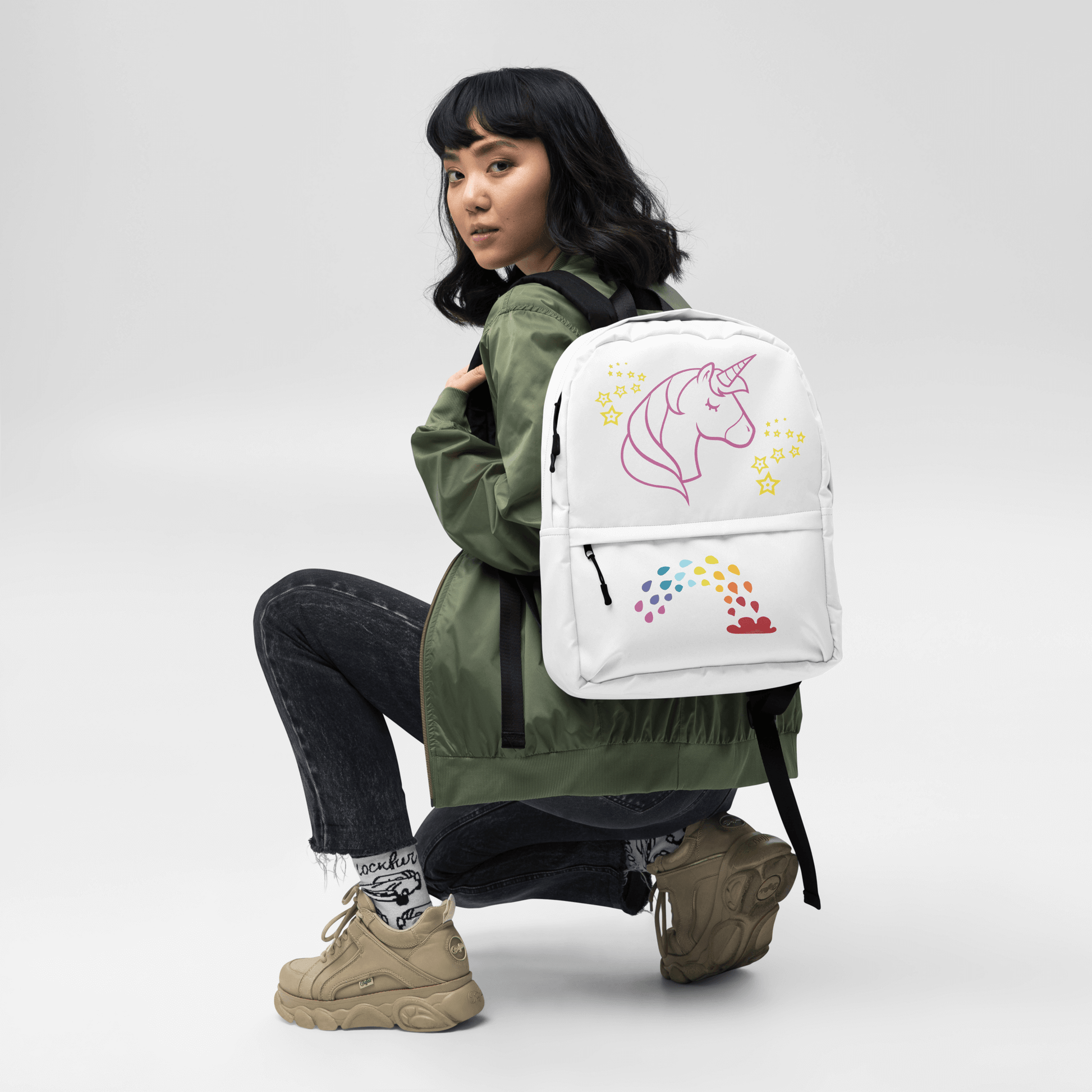 Model showcasing Unicorn Dreams Backpack with whimsical unicorn and rainbow design, perfect for school and adventures.