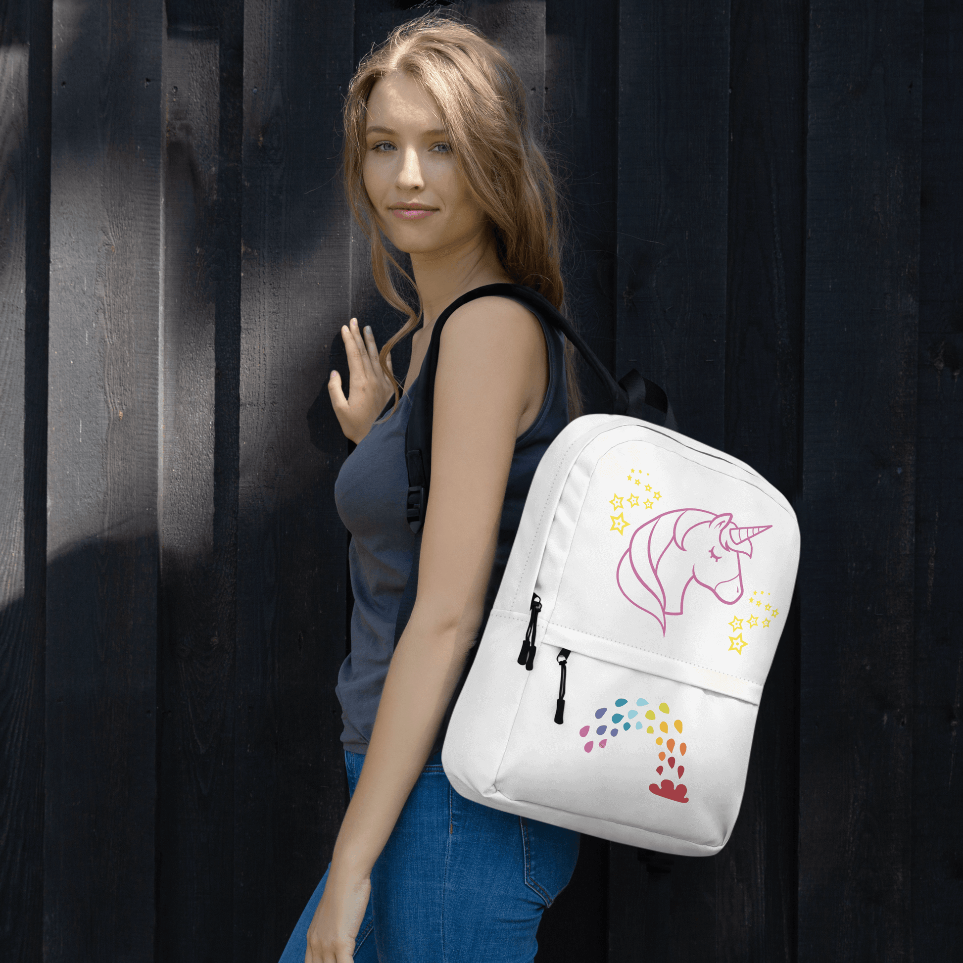 Model carrying Unicorn Dreams Backpack featuring whimsical unicorn design, perfect for school and adventures.