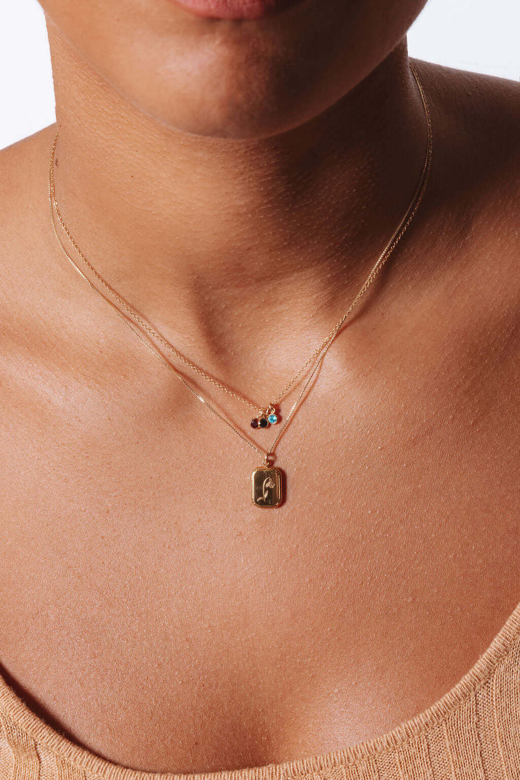 Model wearing the Audrey Birth Flower Necklace – Engraved 18k Gold Over Brass with layered chains.