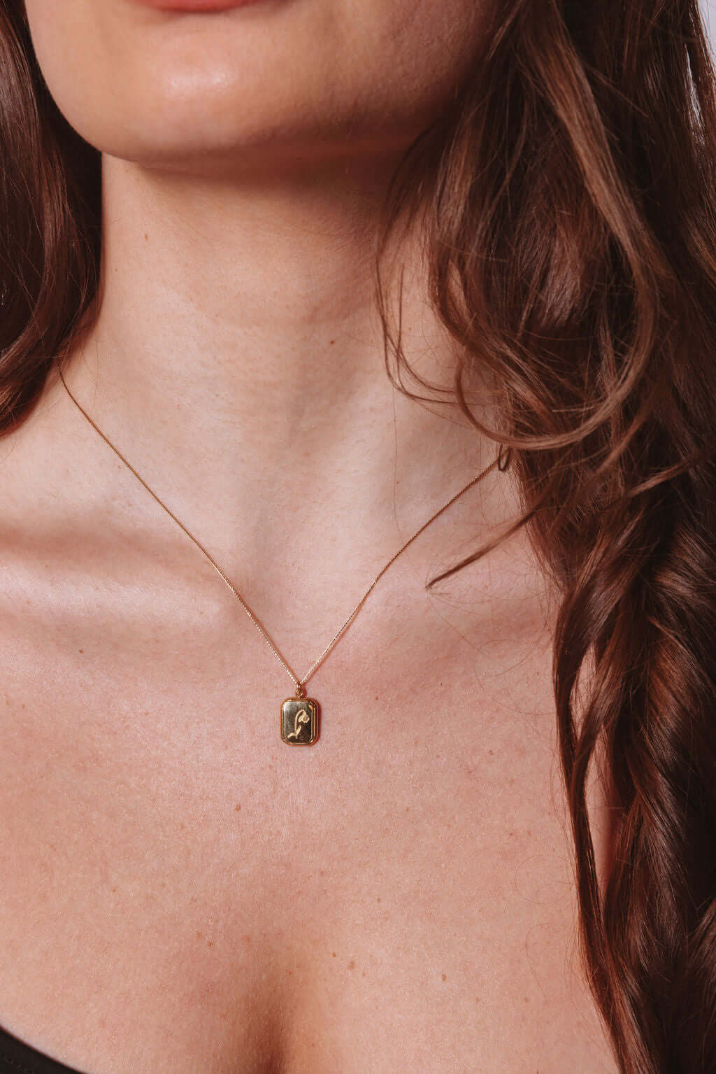 Audrey Birth Flower Necklace – Engraved 18k Gold Over Brass worn by a model, showcasing its elegant design.