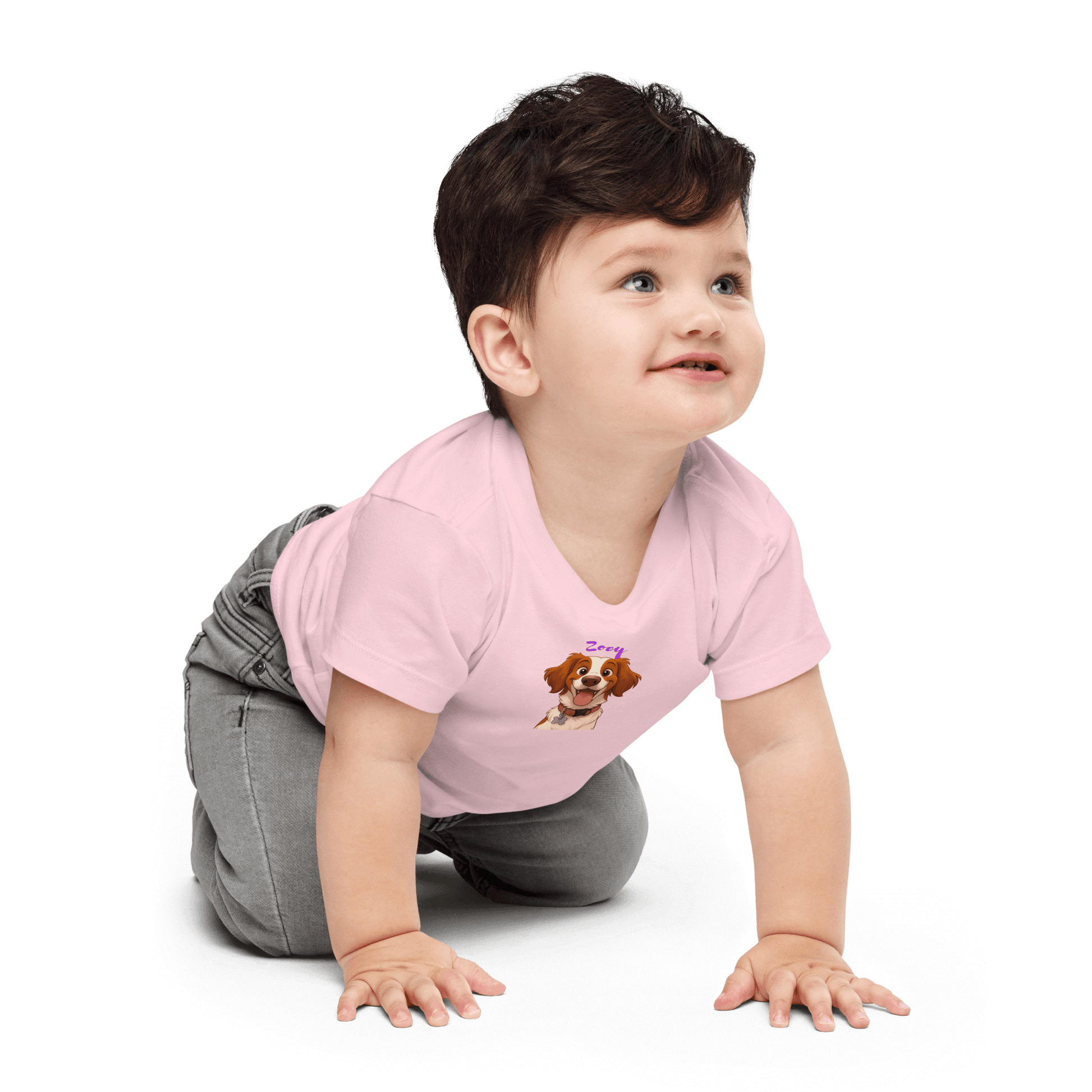 Baby wearing pink tee featuring custom cartoon dog design, smiling while crawling.