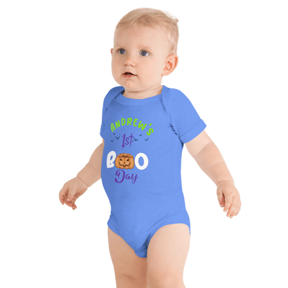 Baby wearing personalized blue bodysuit with pumpkin design celebrating 1st Halloween, featuring playful spooky text.