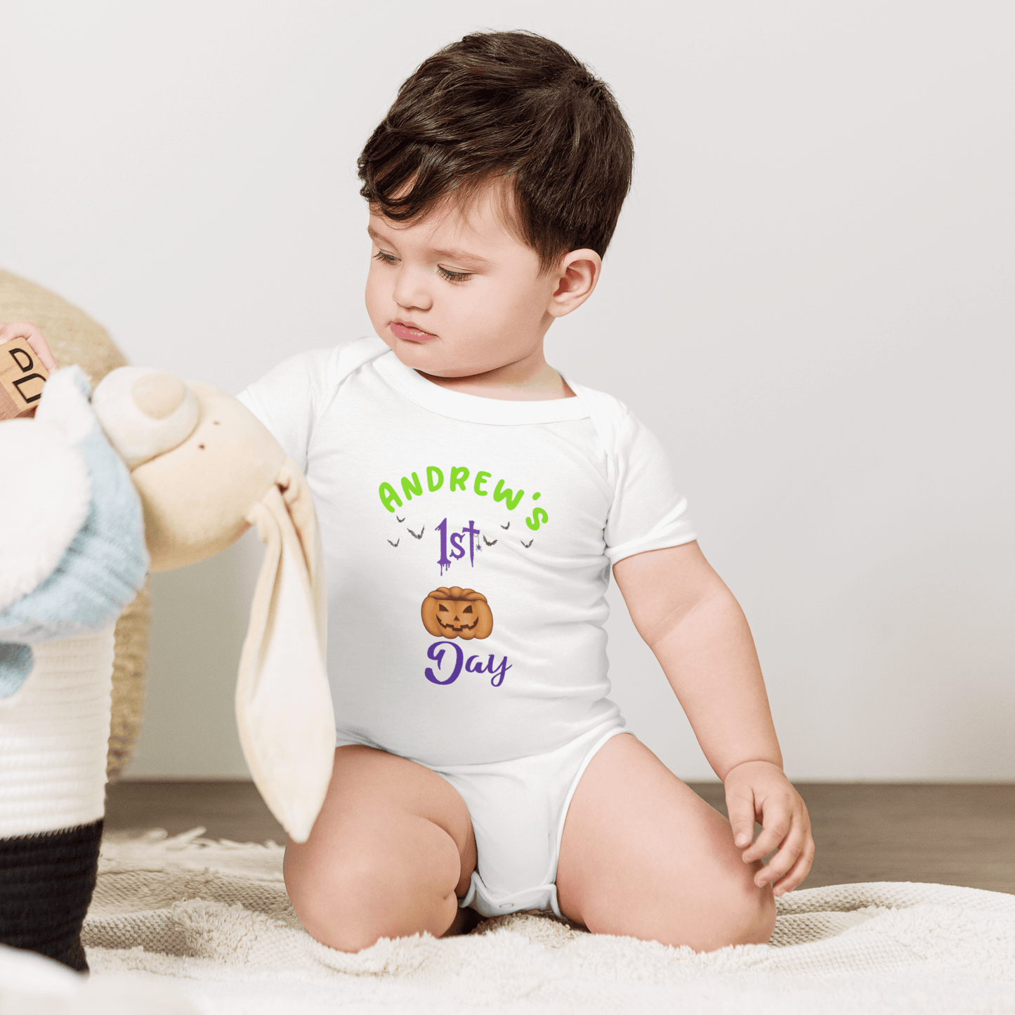 Personalized baby bodysuit with 'Andrew's 1st Day' text in colorful design, perfect for Halloween celebrations.