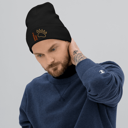 Bear Beanie – Embroidered Knit Hat with Custom Text worn by a man in a cozy setting, showcasing the embroidered bear paw design.