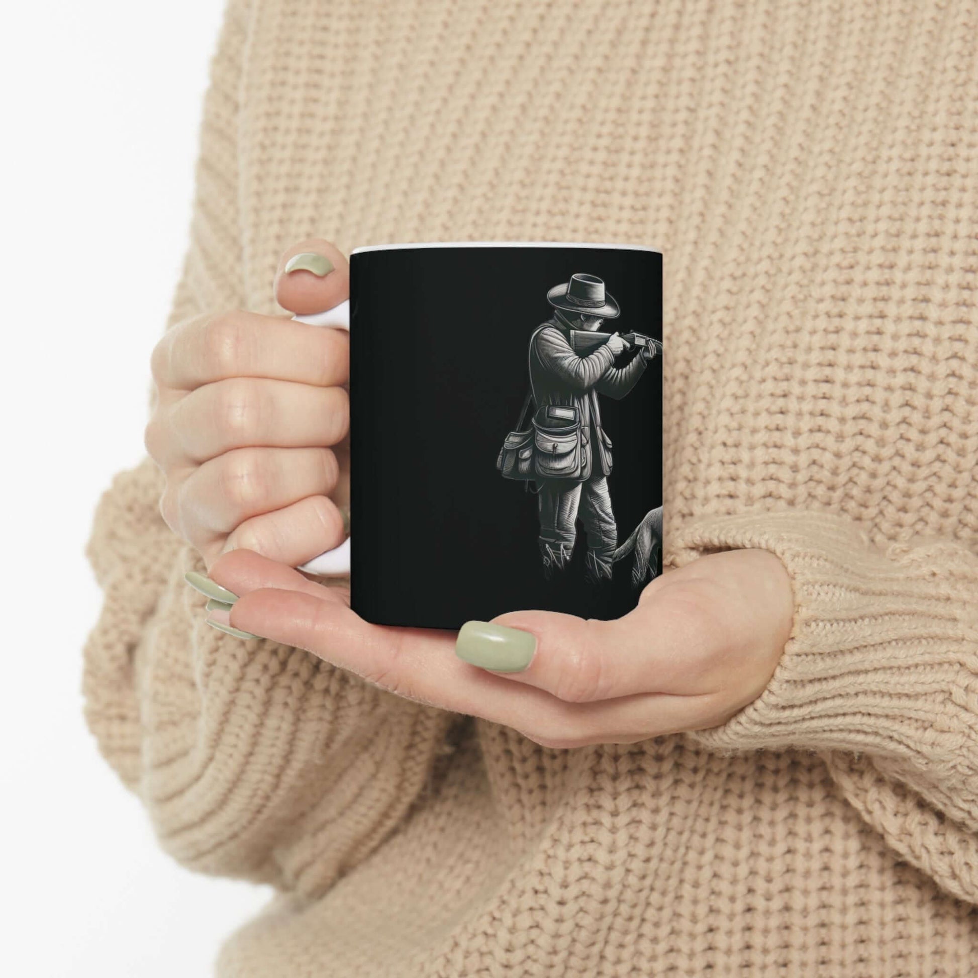 Personalized black hunting mug held by a person in a cozy sweater, perfect for outdoor enthusiasts.