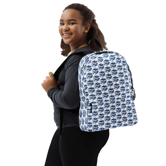 Smiling girl wearing The Bookish Backpack with geometric book pattern, perfect for daily carry and style.