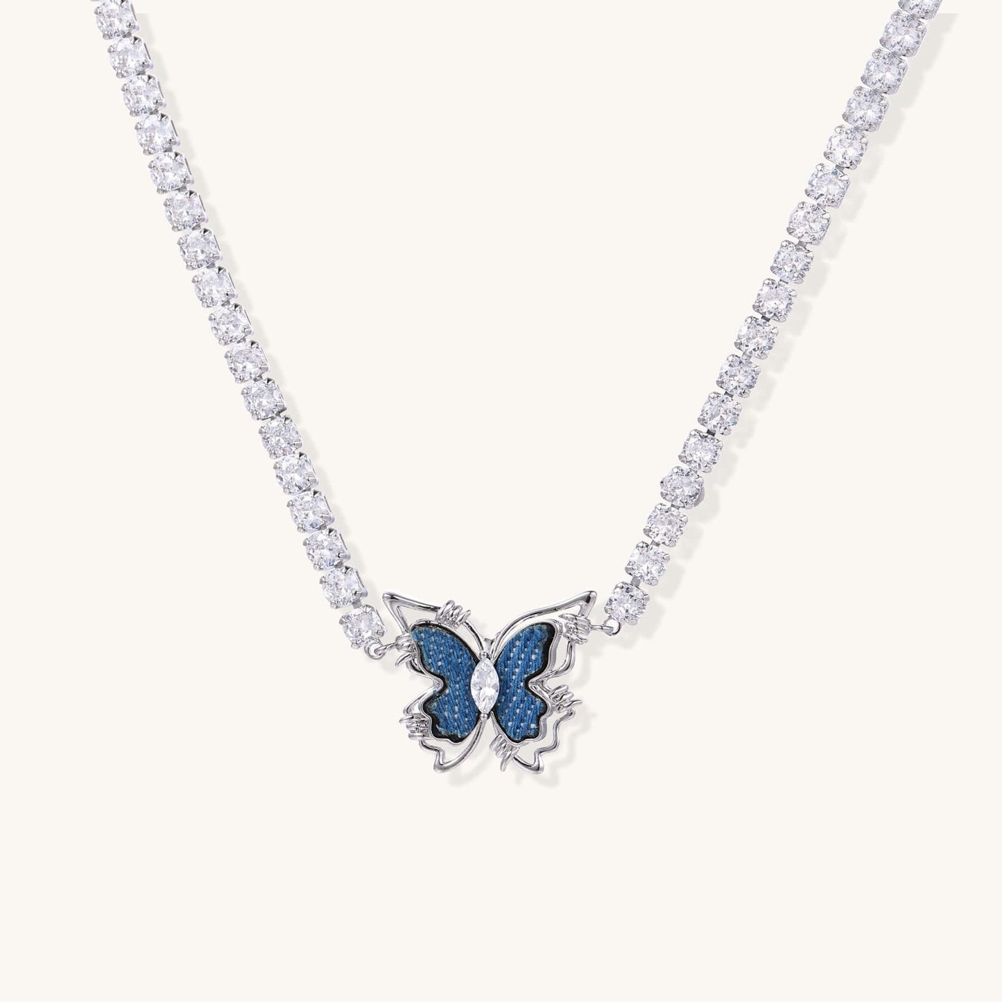 Butterfly Dreams Tennis Necklace with Blue Wings and Gold Chain features a butterfly pendant and sparkling zirconia chain.