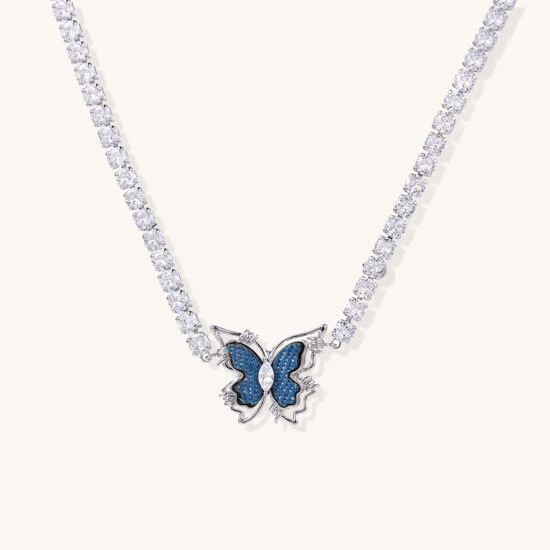 Butterfly Dreams Tennis Necklace with Blue Wings and Gold Chain features a butterfly pendant and sparkling zirconia chain.