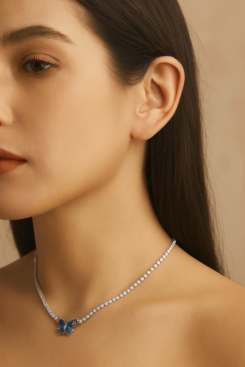 Butterfly Dreams Tennis Necklace with Blue Wings and Gold Chain worn by a model showcasing its elegance and charm.