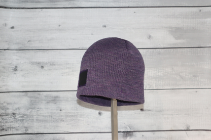 Child Acrylic Wool Beanie – Soft Winter Hat for Kids displayed on a stand with a purple color.