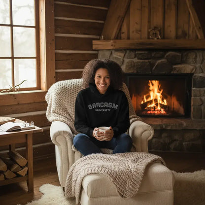 Custom College Hoodie – Your Mantra, Your Mood worn by woman in cozy cabin with fire.