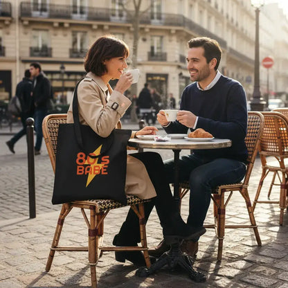 A couple enjoying coffee at an outdoor cafe, featuring a Custom Double-Sided Cotton Canvas Tote – Upload Two Designs.