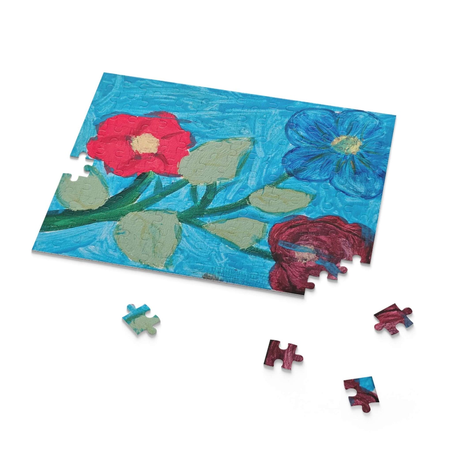 Colorful floral puzzle pieces on blue background, perfect for creating custom memories and fun family activities.
