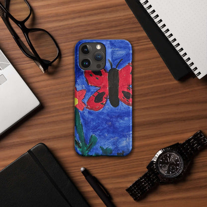 Custom iPhone Case with Your Pics: Snap Your Style featuring a colorful butterfly design on a wooden desk.