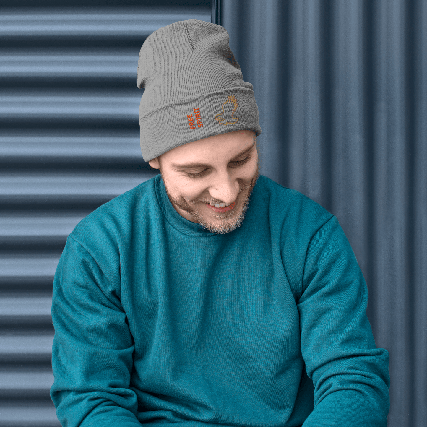 Eagle Beanie – Embroidered Knit Hat with Custom Text worn by a smiling man in a teal sweater, showcasing a stylish design.