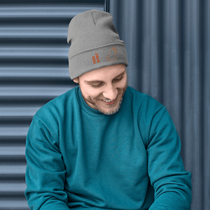 Eagle Beanie – Embroidered Knit Hat with Custom Text worn by a smiling man in a teal sweater, showcasing a stylish design.