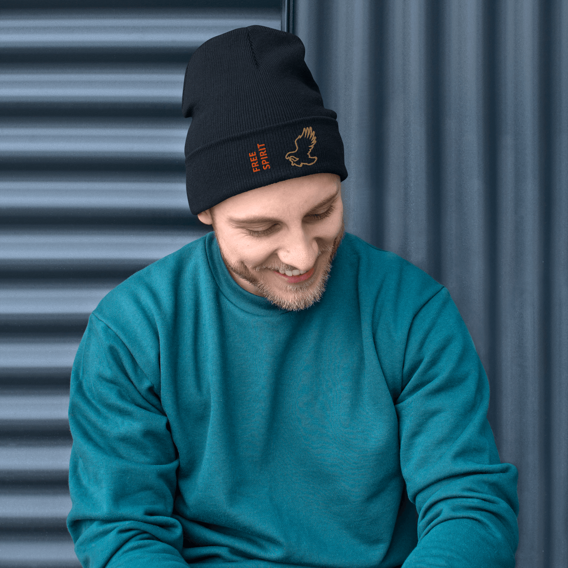 Eagle Beanie – Embroidered Knit Hat with Custom Text worn by a smiling man in a teal sweater.